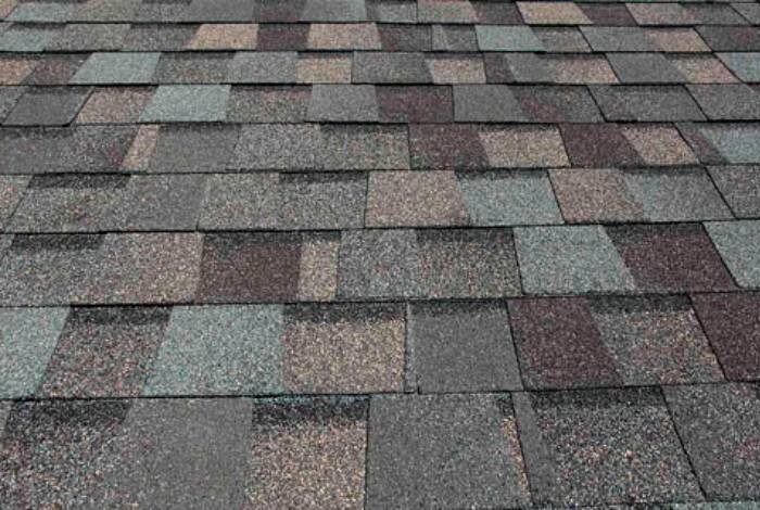 A beautifully crafted roof featuring an array of colorful shingles, exemplifying the quality work of Alom Builders.